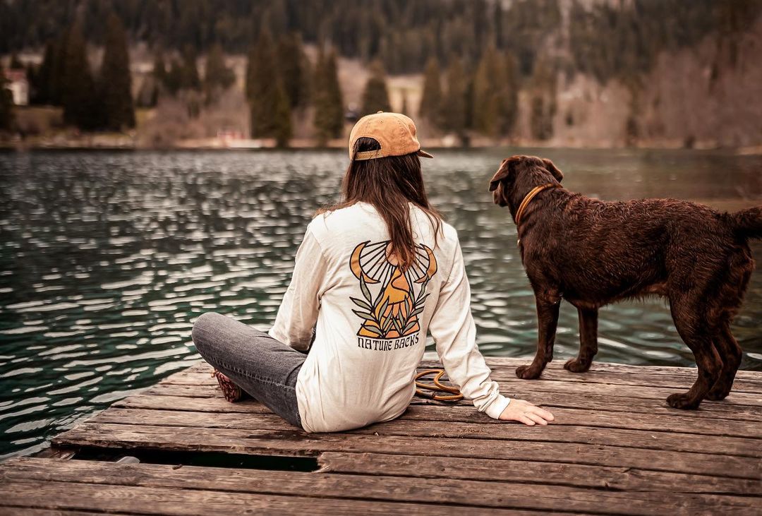Person wearing Mirage On a dock with a dog