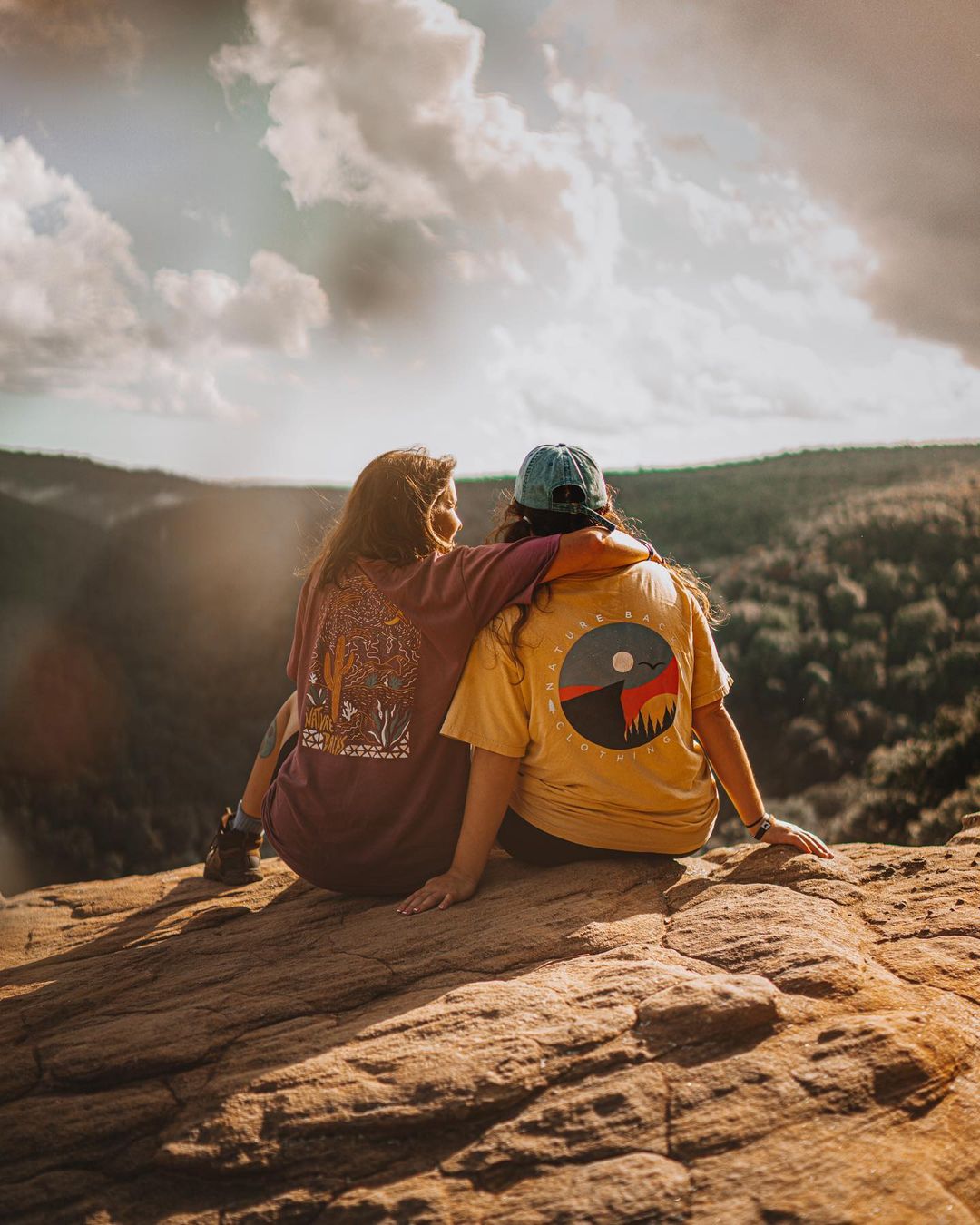 Two People On Top Of A Mountain