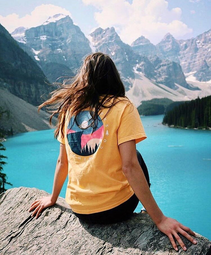 Sunrise shirt in front of beautiful blue waters and mountains