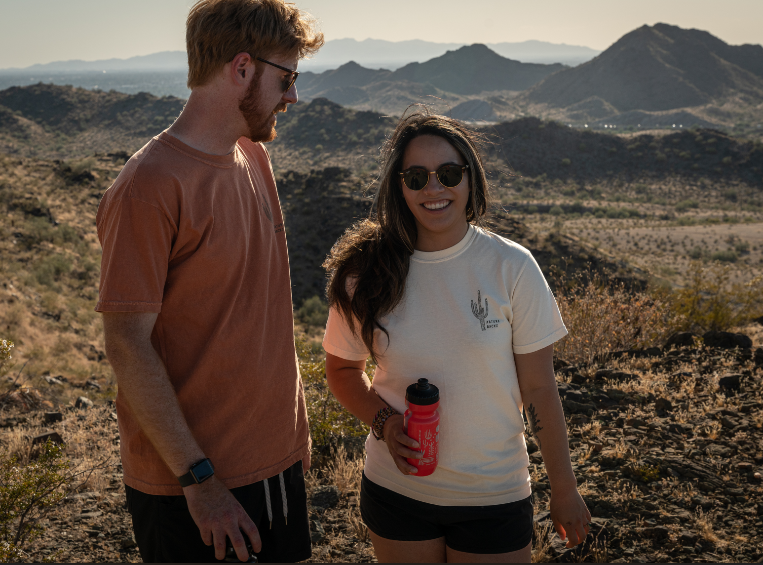 Two people standing in the desert with Saguaro on 